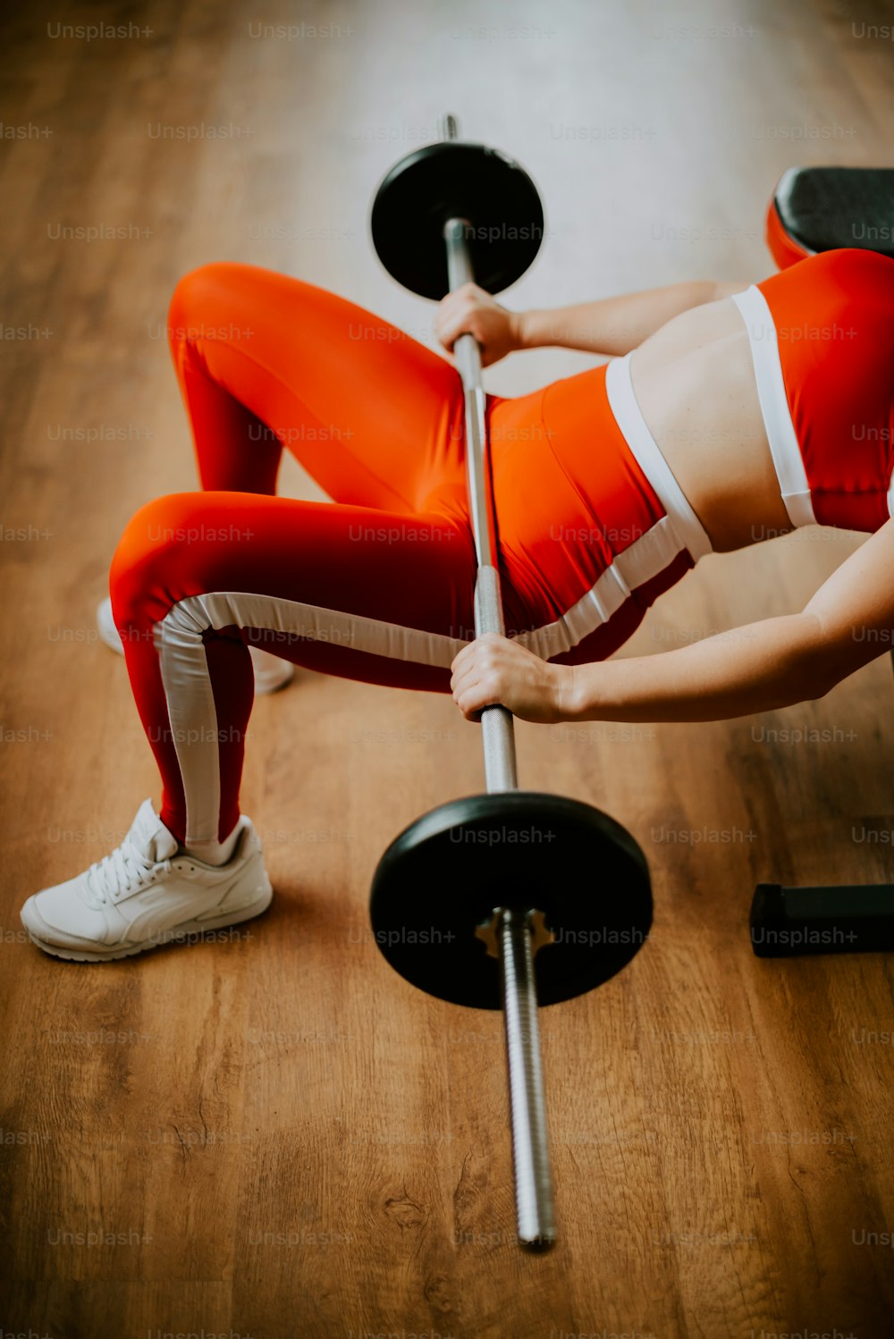 a woman is doing a pull up with a bar