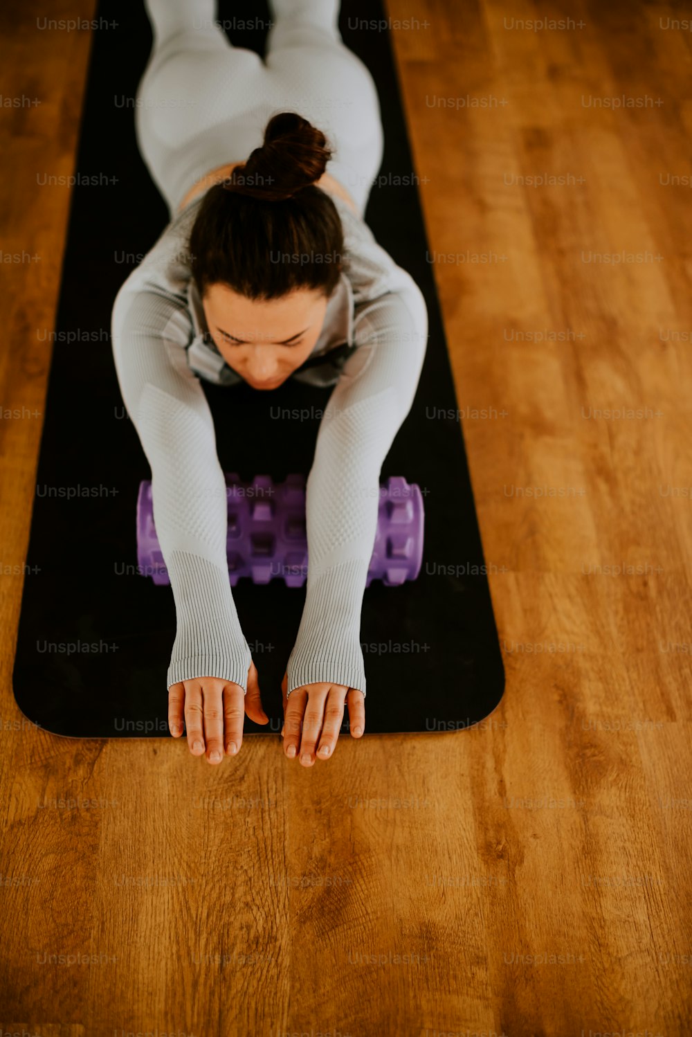 a woman is doing yoga on a mat