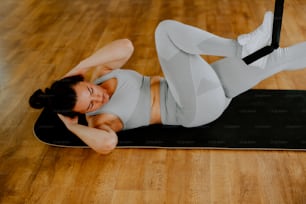 a woman laying on top of a yoga mat