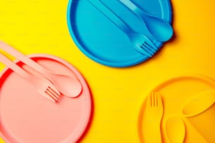 a plastic plate with a fork and a spoon on it