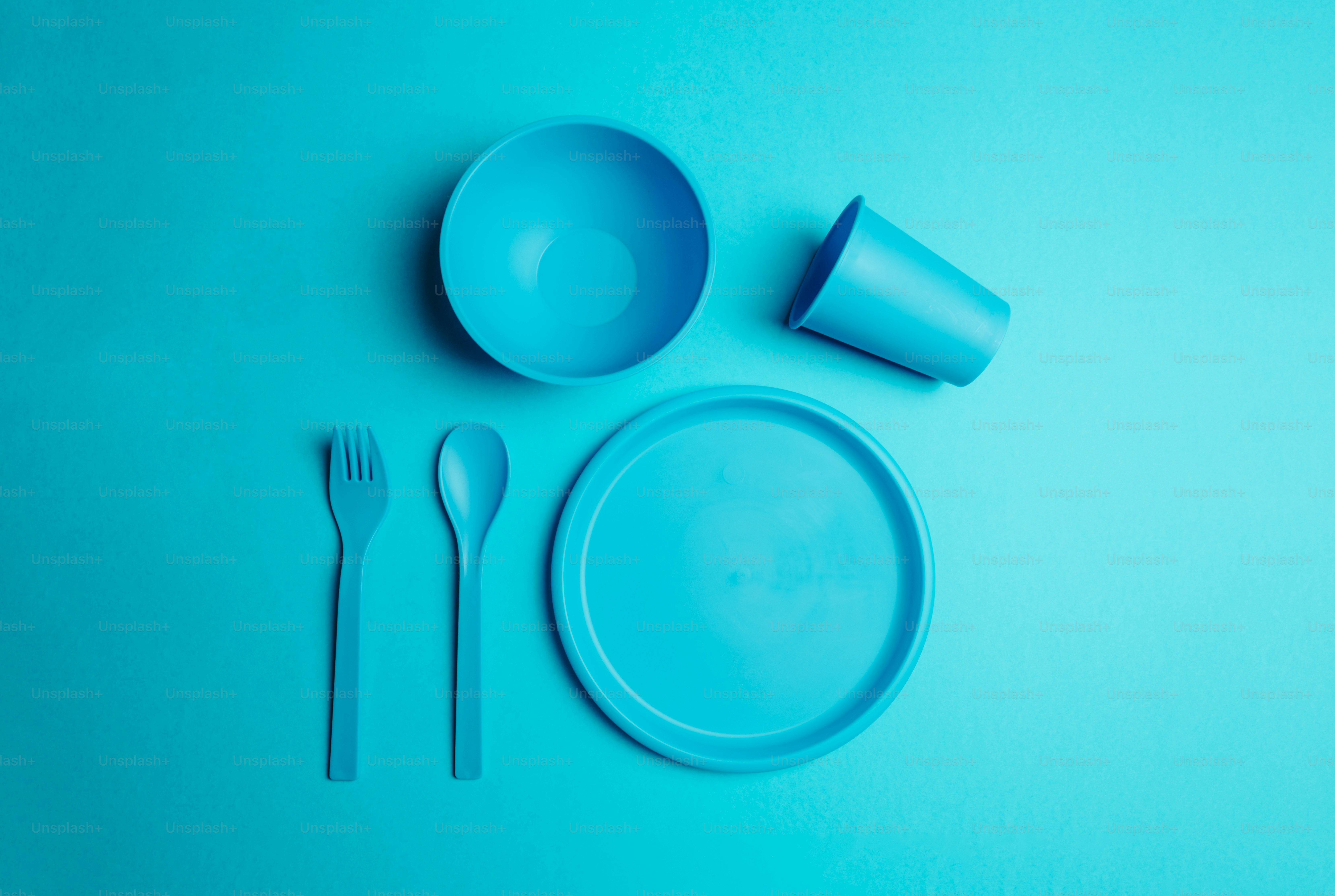a blue table setting with a plate, fork and knife