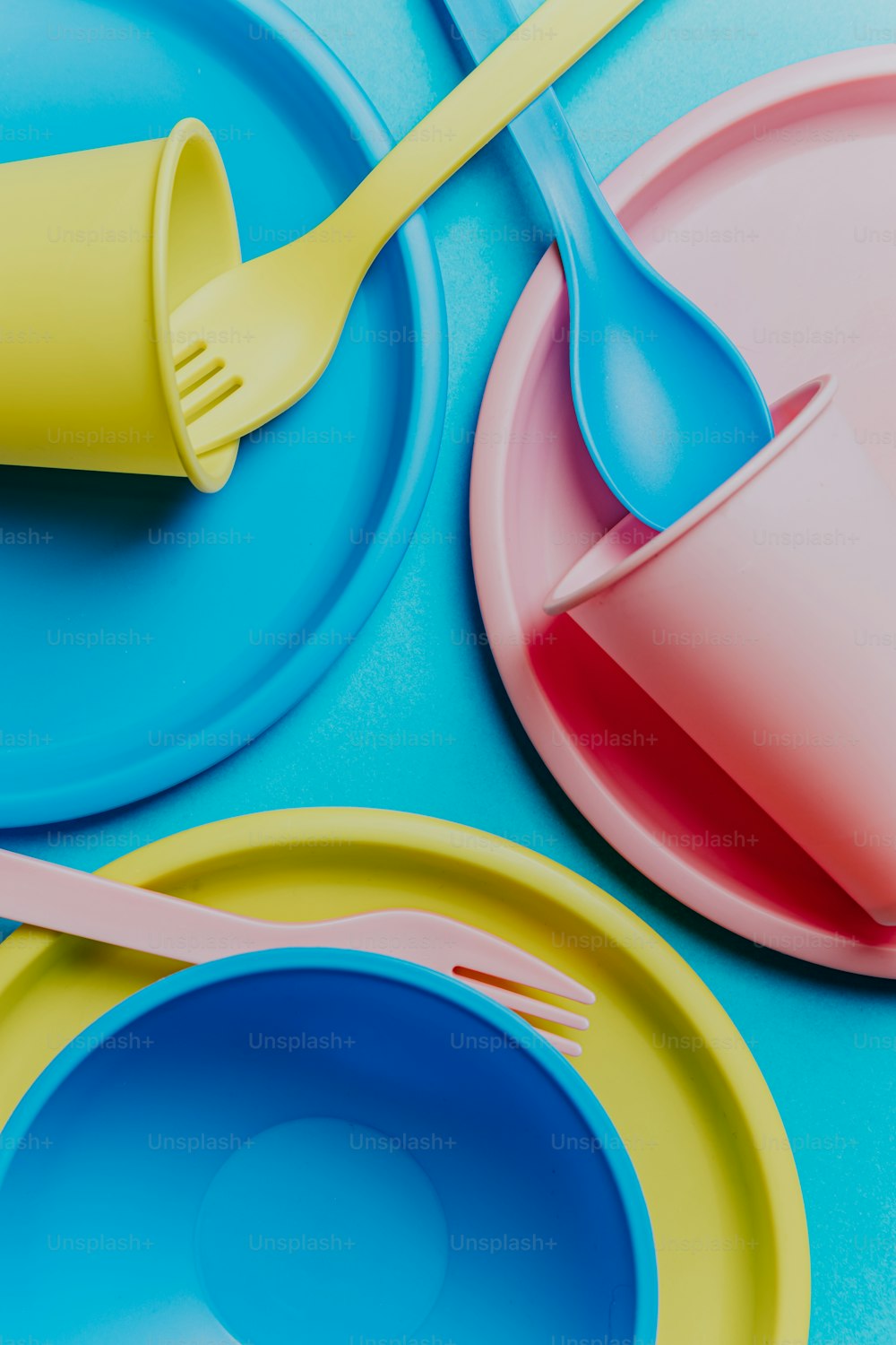 a close up of a plate with a fork and a cup on it