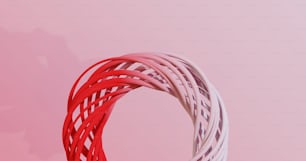 a close up of a red and white object on a pink background