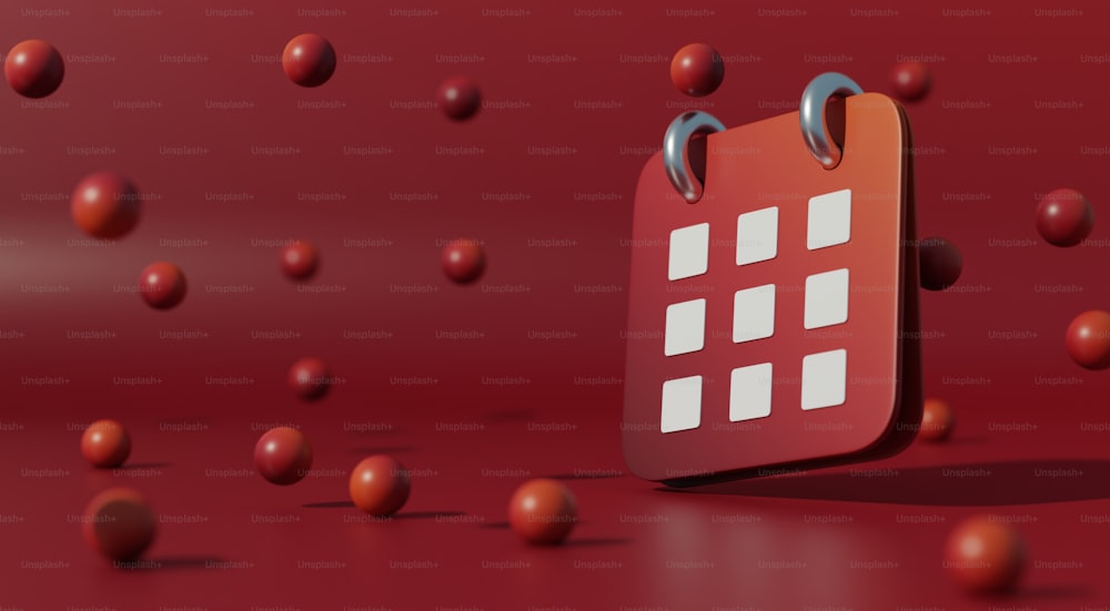 Ein rot-weißer Kalender, umgeben von roten Kugeln