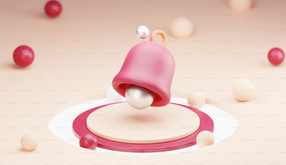 a pink object with a pearl on top of it