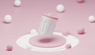 una tazza bianca con un coperchio rosa circondato da palline rosa e bianche
