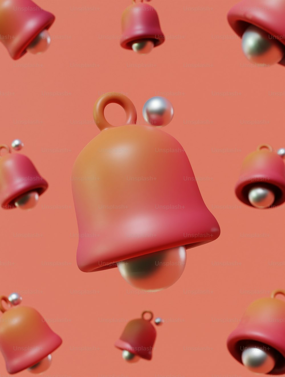 a bunch of bells that are on a pink surface