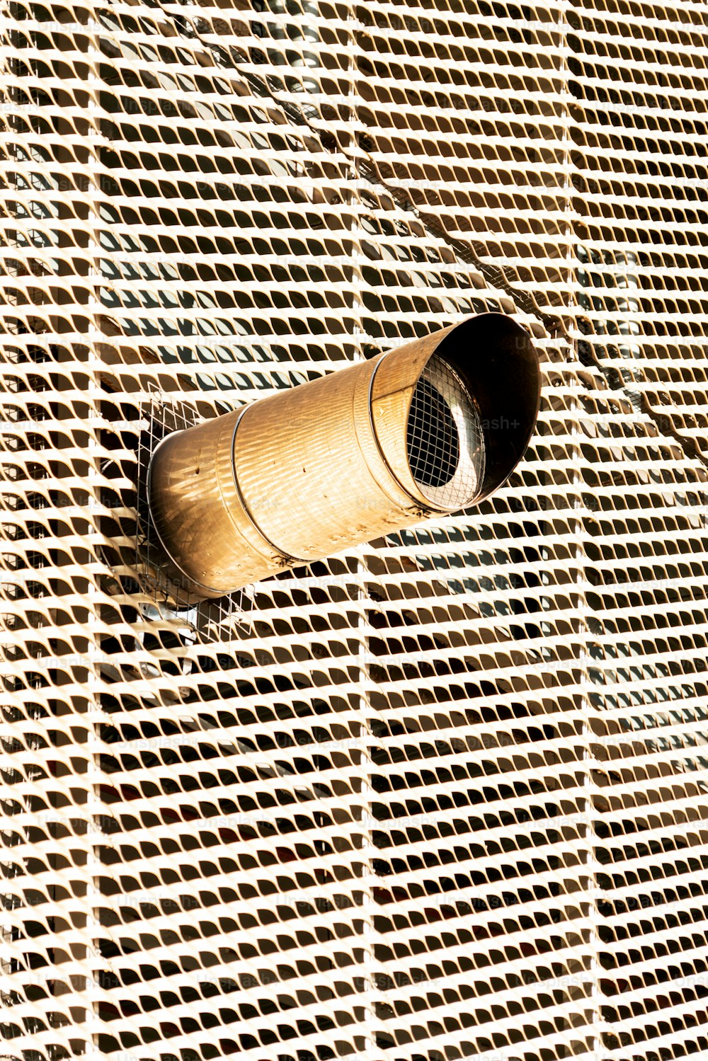 an air vent mounted to the side of a building