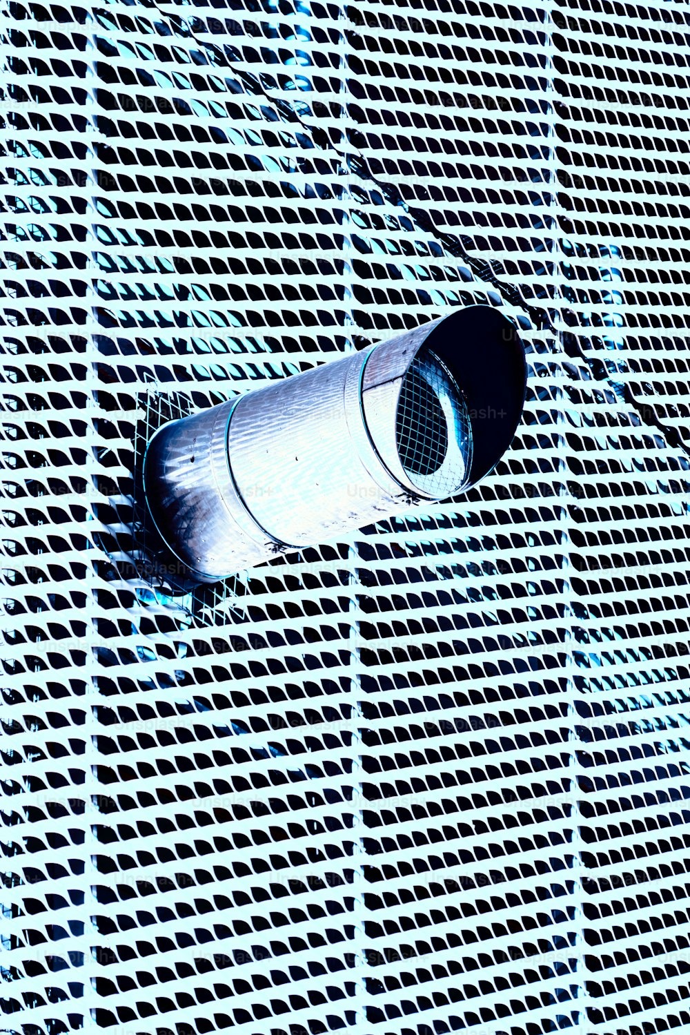 an air vent mounted to the side of a building