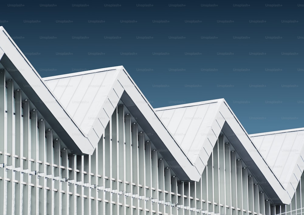 a row of white buildings with a blue sky in the background