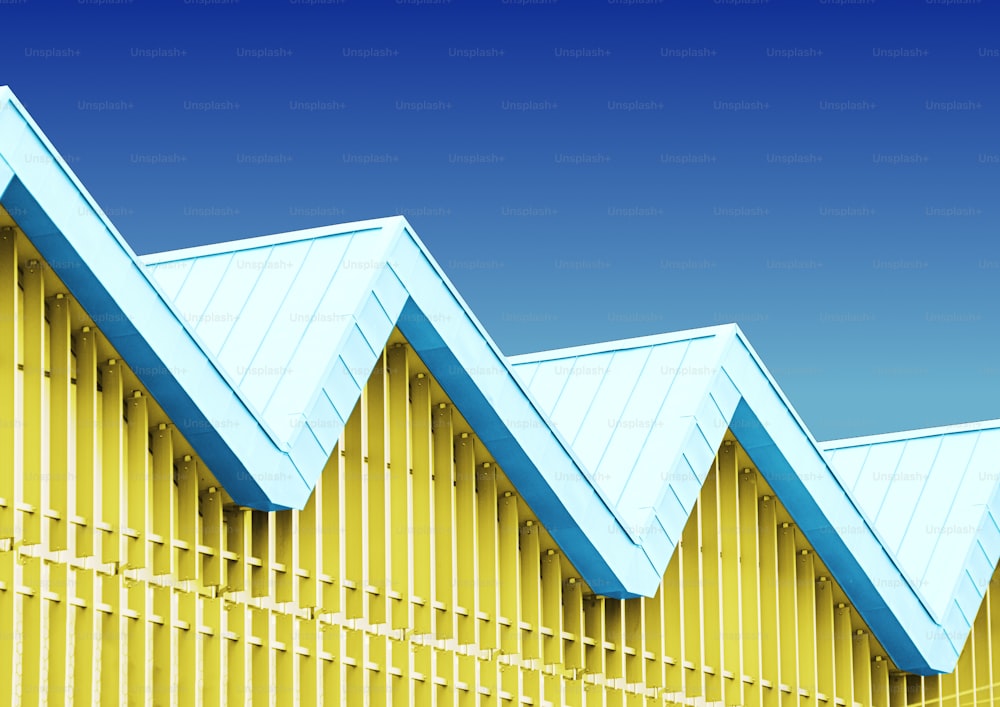 a row of blue and yellow roof tops against a blue sky