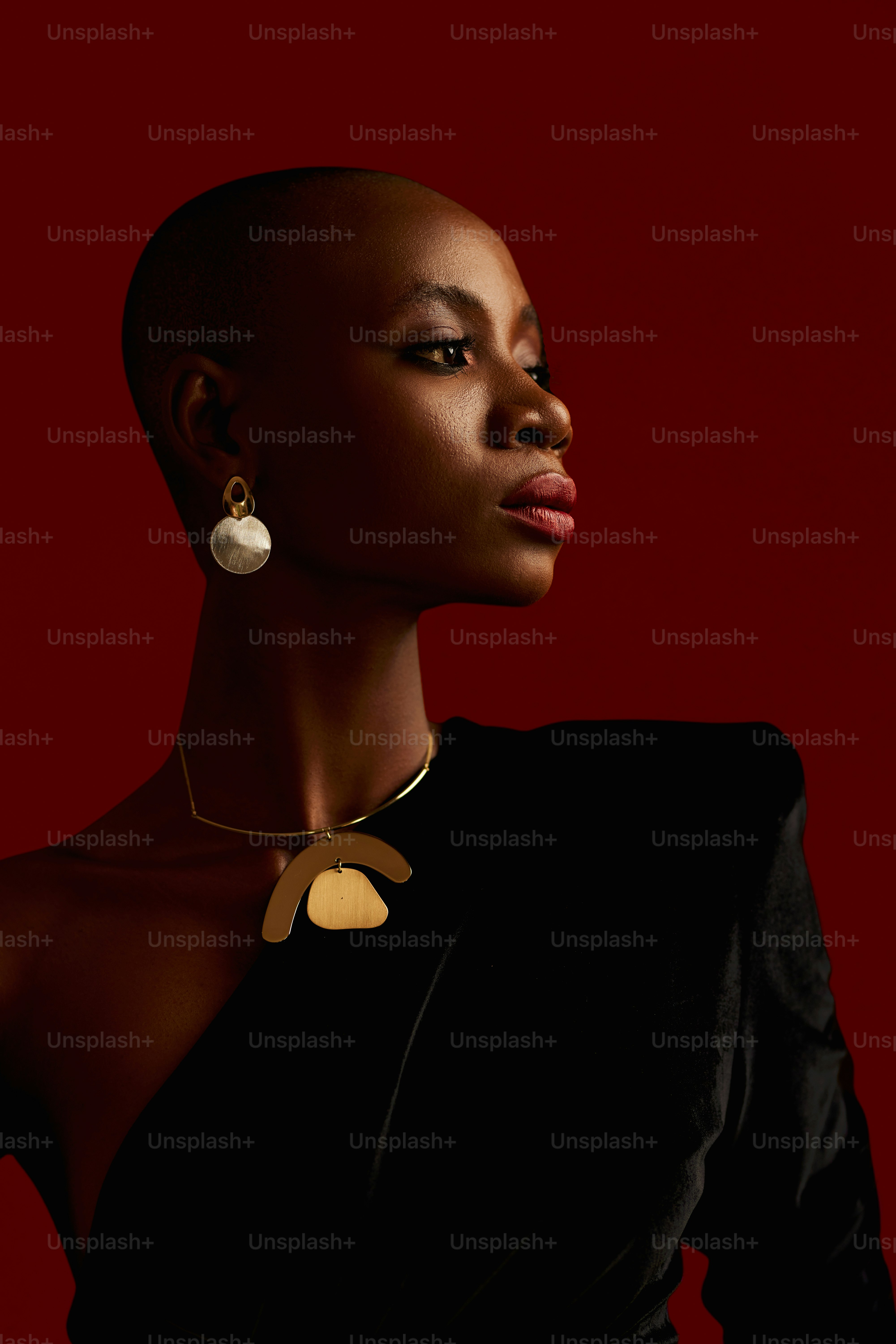 a woman wearing a black dress and a gold necklace