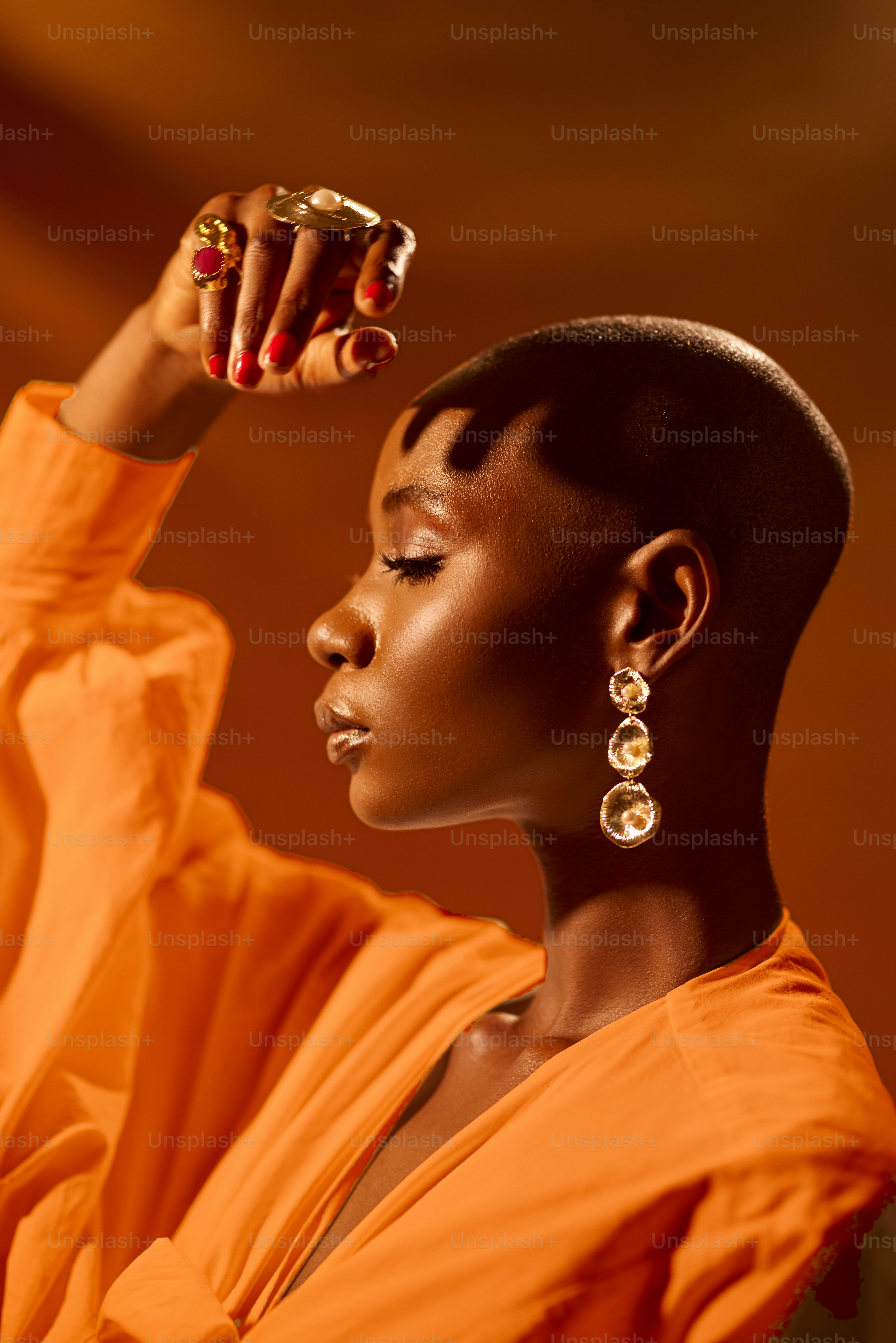 a woman in an orange dress holding a cell phone