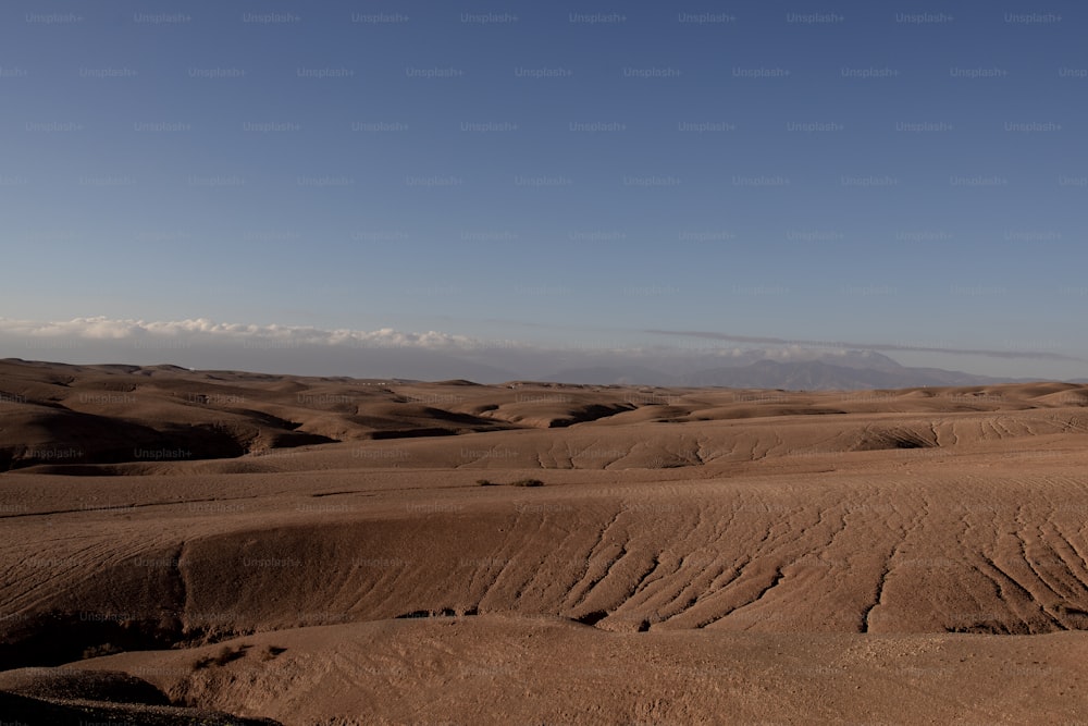a view of a desert with a sky in the background