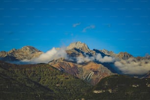 a view of a mountain range with clouds in the sky