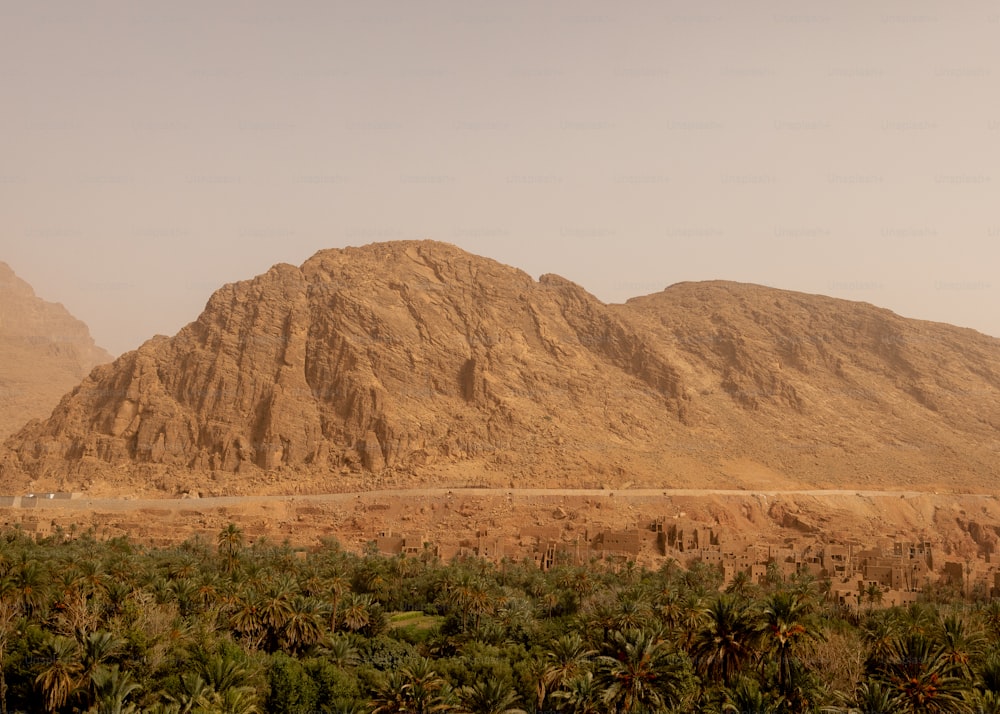 a large mountain in the middle of a desert