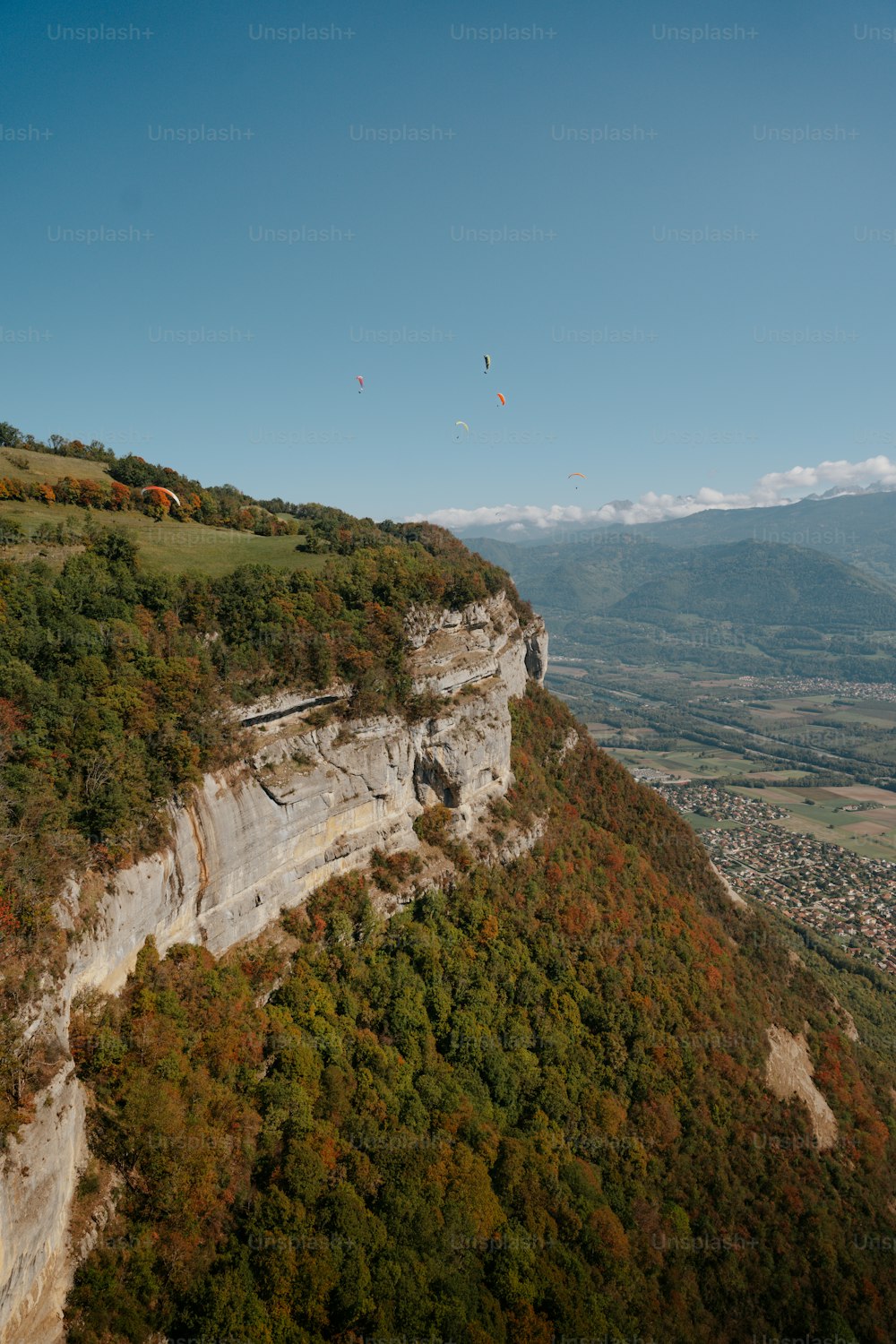 a view of a cliff with a mountain in the background