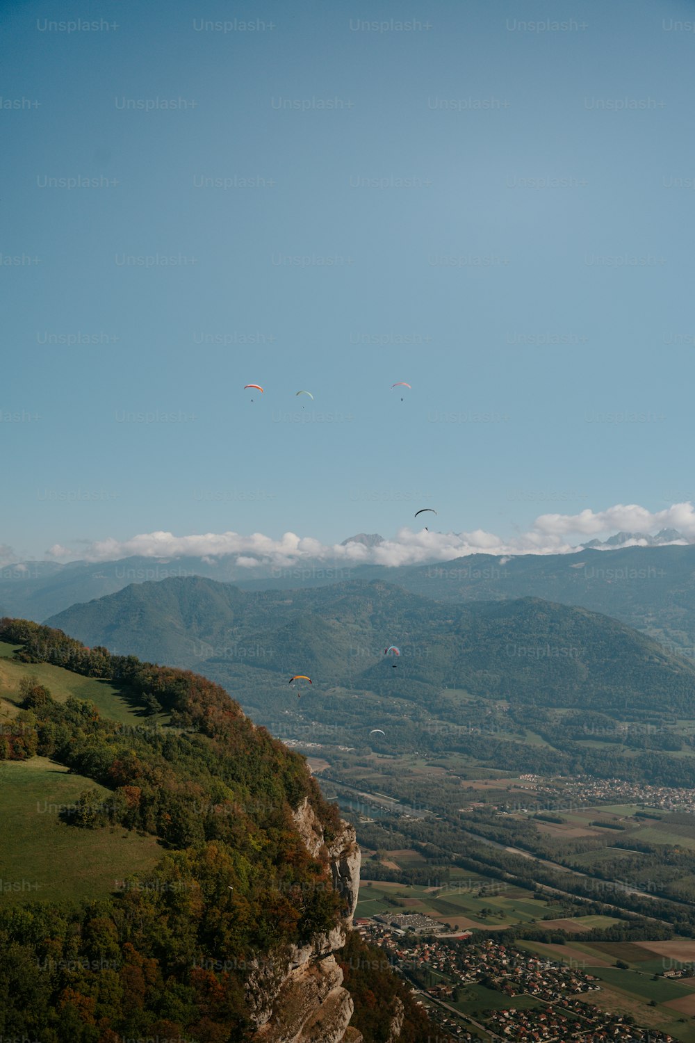 um grupo de pessoas empinando pipas no topo de uma montanha