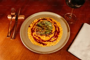 a plate of food and a glass of wine on a table
