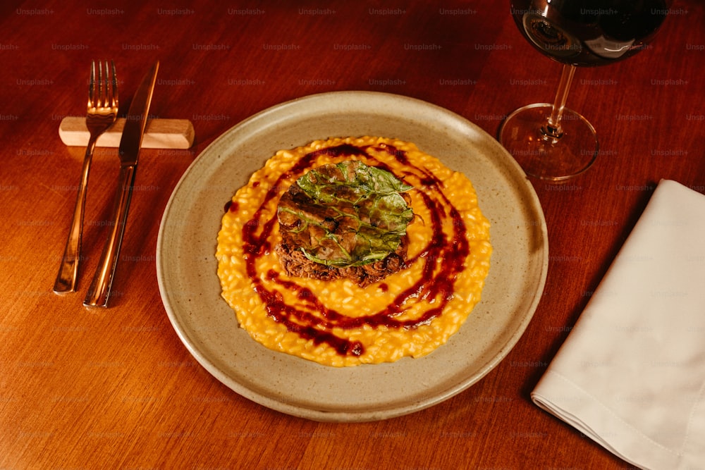 a plate of food and a glass of wine on a table