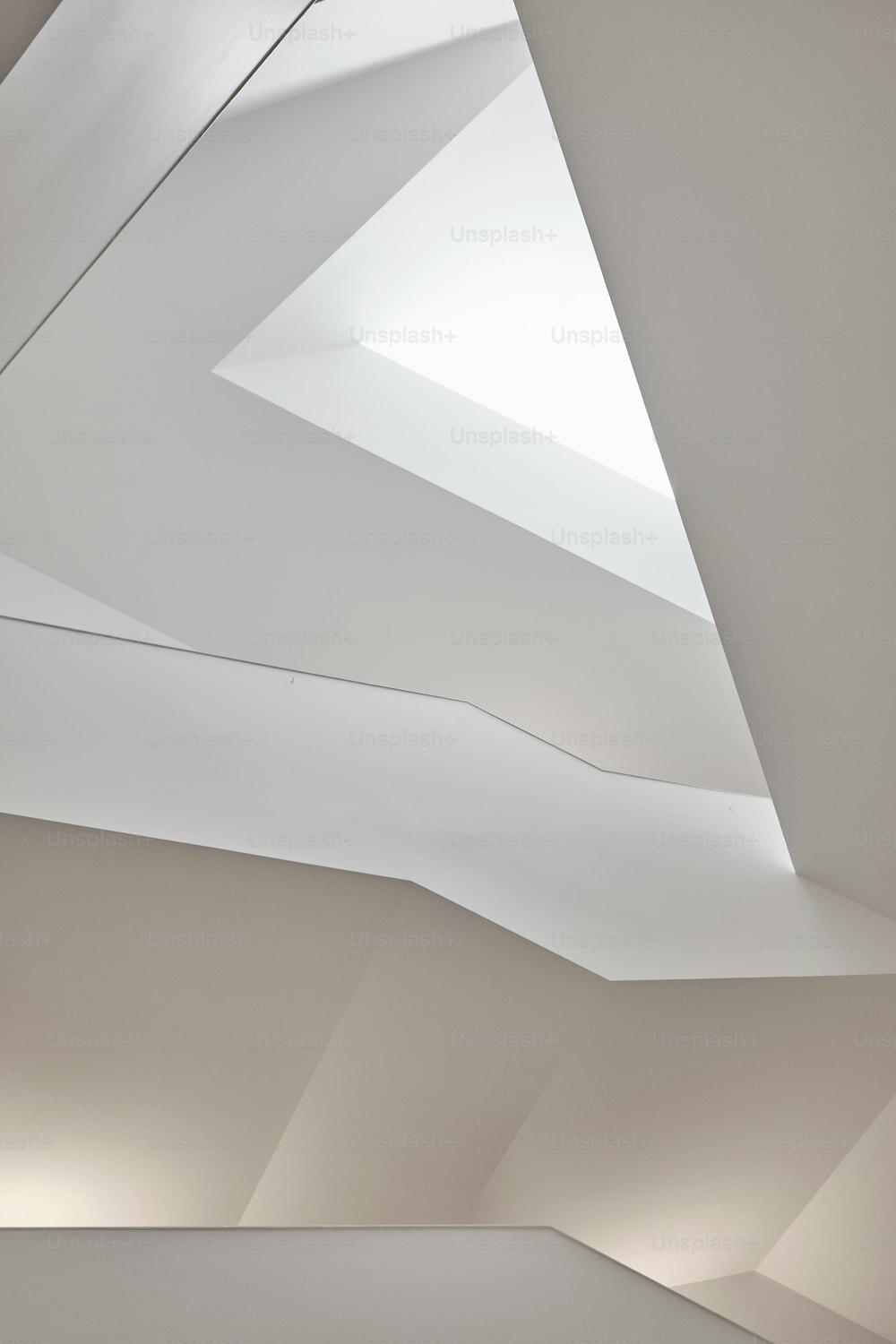 a room with a skylight and a white ceiling