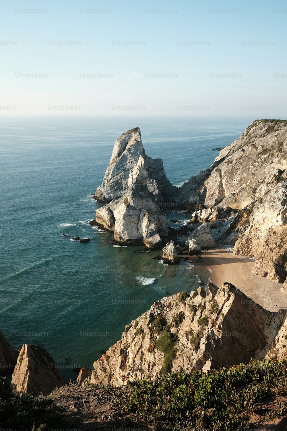 a view of the ocean from the top of a hill