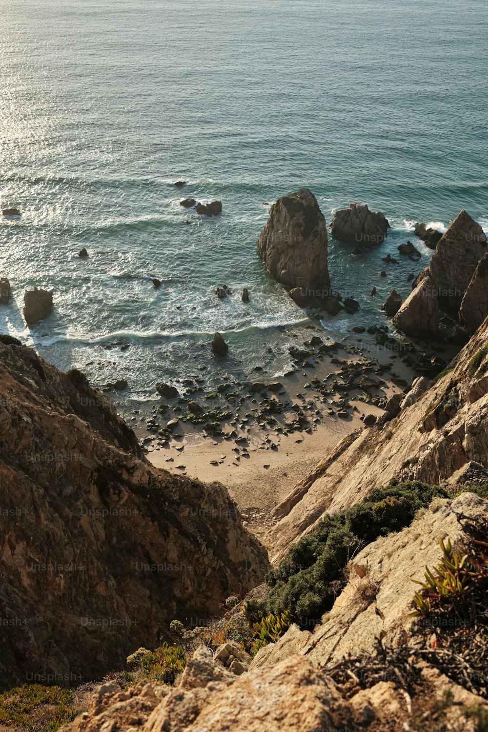 a view of the ocean from the top of a hill