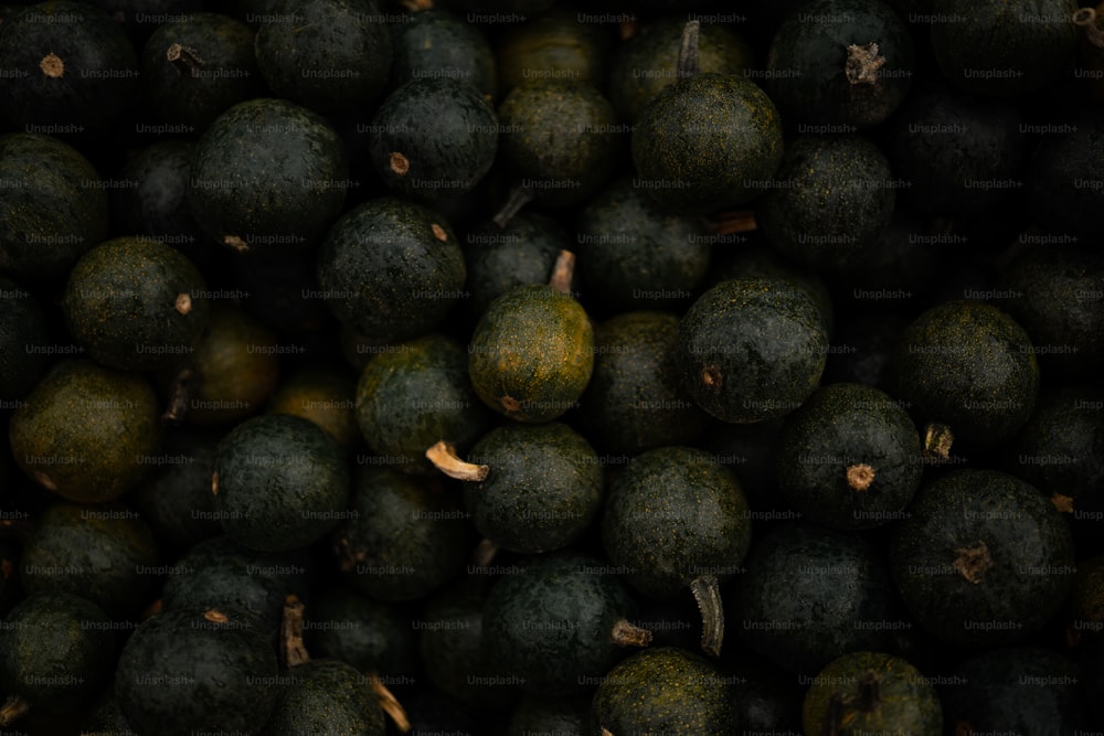 a pile of green fruit sitting next to each other