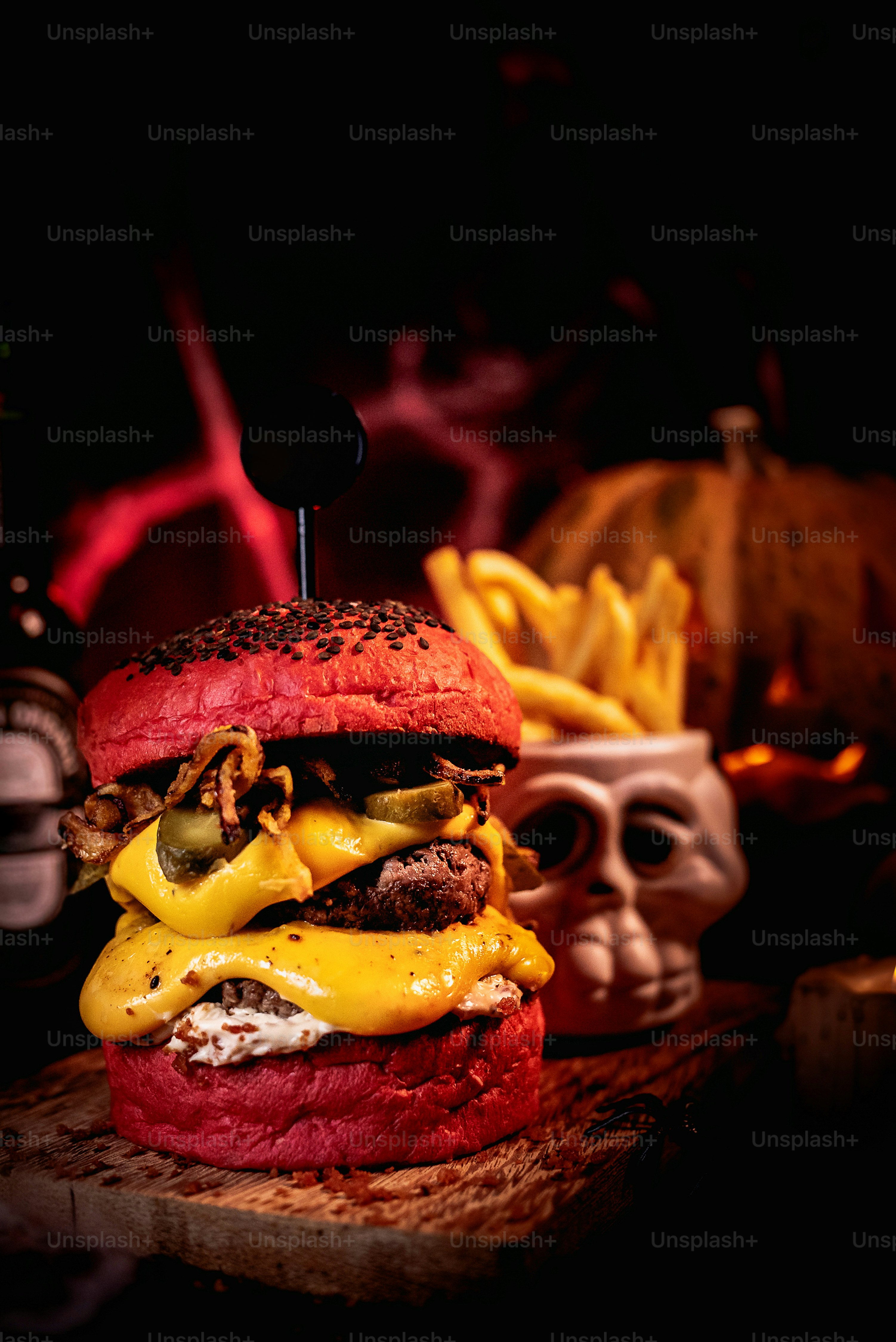 a large hamburger with cheese and other toppings