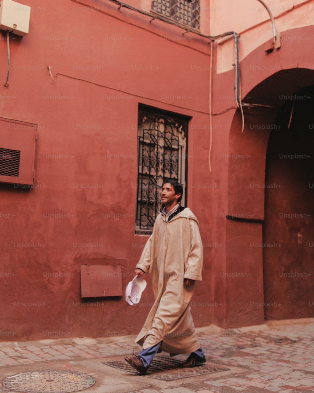 a man is walking down the street with a frisbee