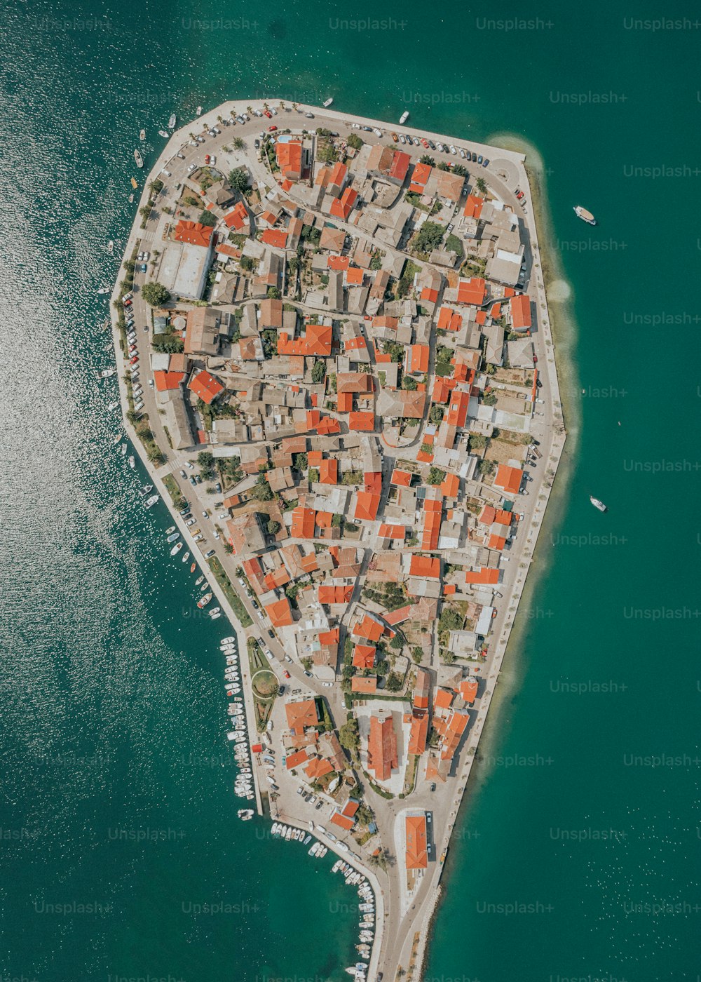 an aerial view of a small town on the water