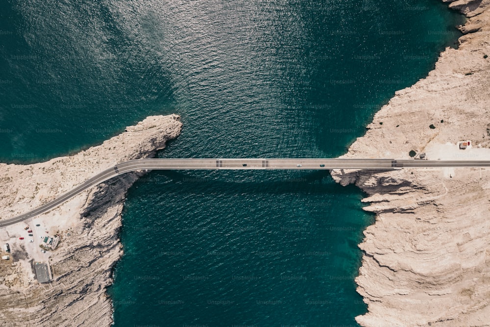 an aerial view of a bridge over a body of water