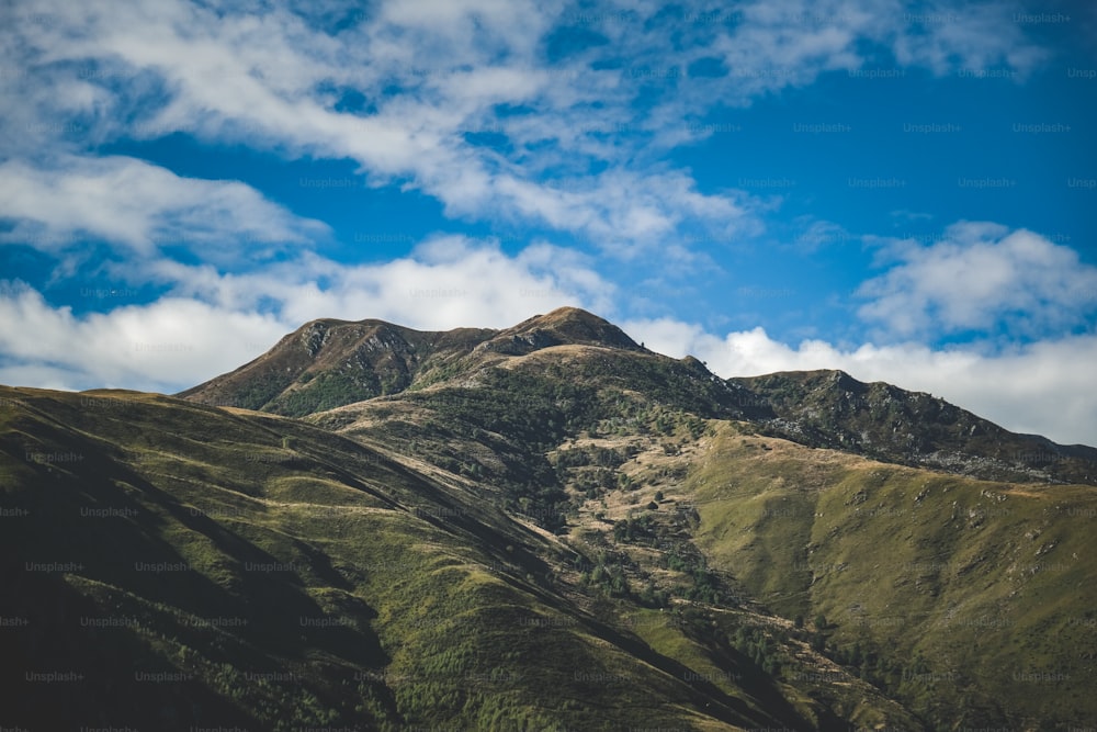 a view of a mountain range with a blue sky in the background