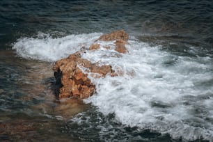 a rock in the middle of the ocean