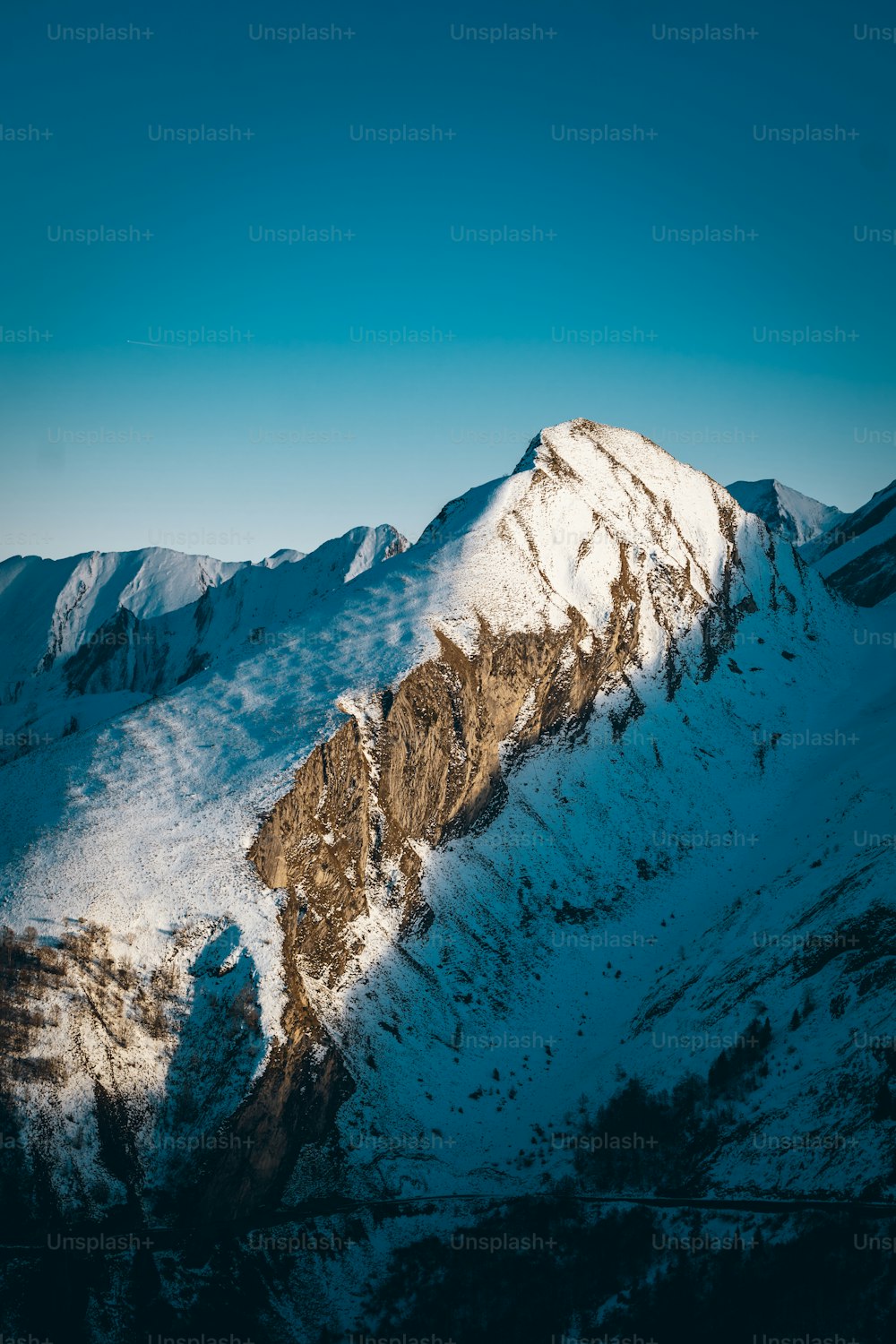 a mountain covered in snow under a blue sky