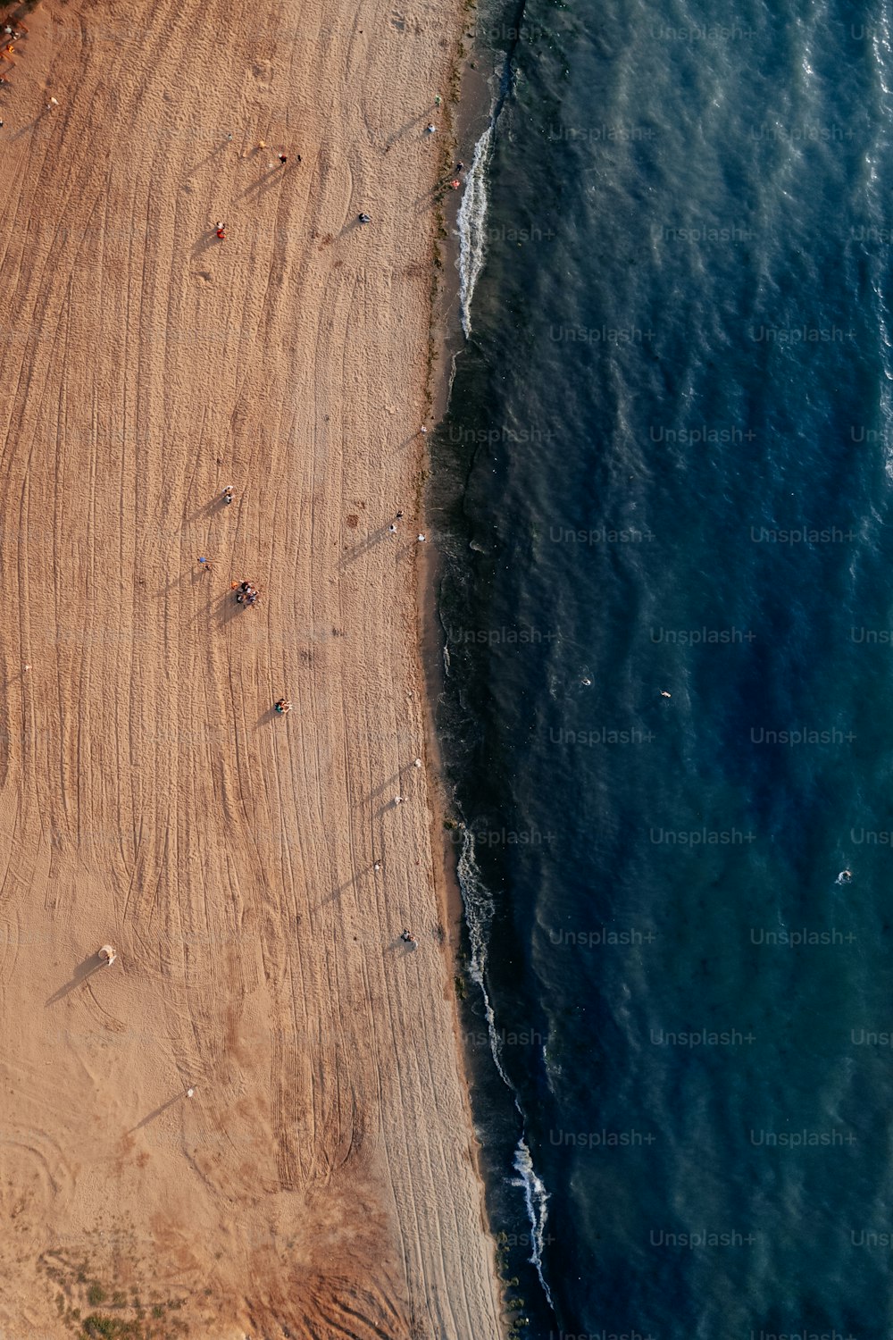 an aerial view of a sandy beach and ocean