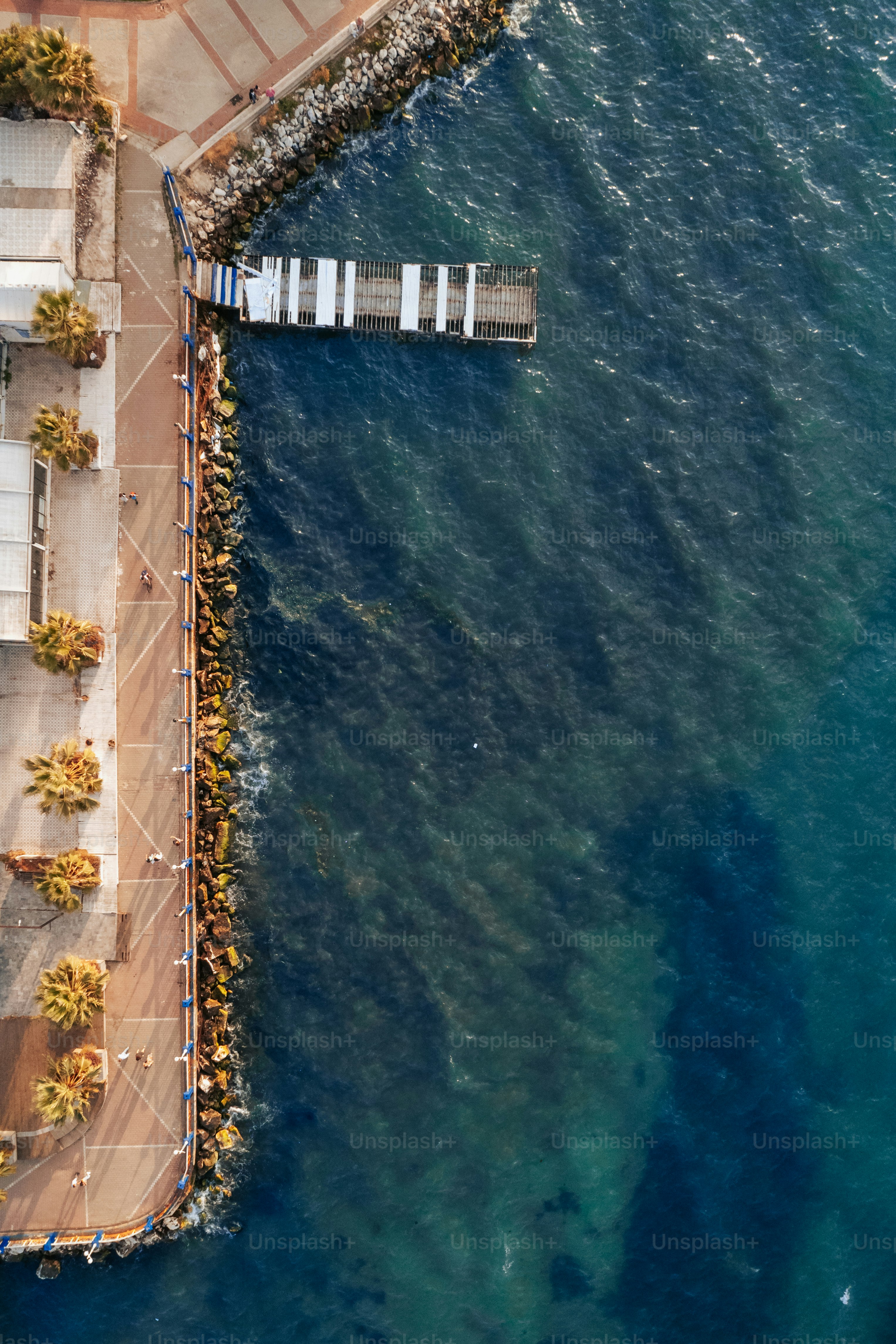 an aerial view of a pier in the ocean