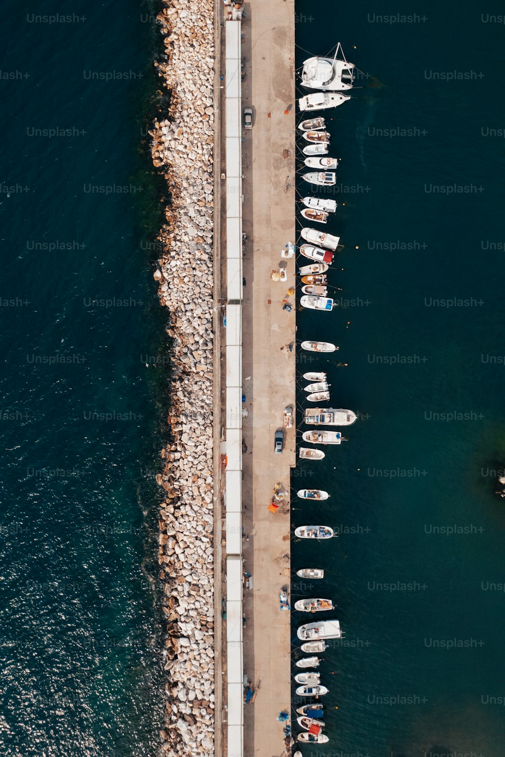 an aerial view of a pier with boats in the water