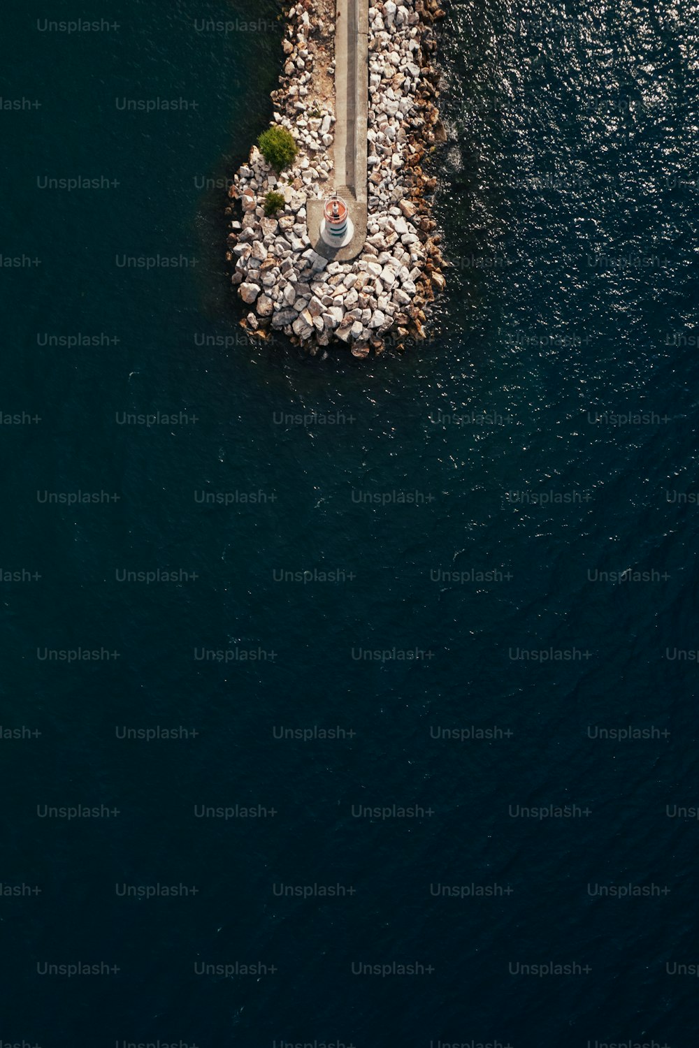 an aerial view of a road crossing a body of water