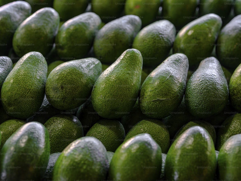 a pile of avocados sitting next to each other