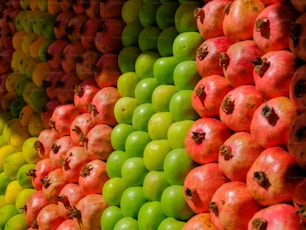 a large display of apples and other fruits