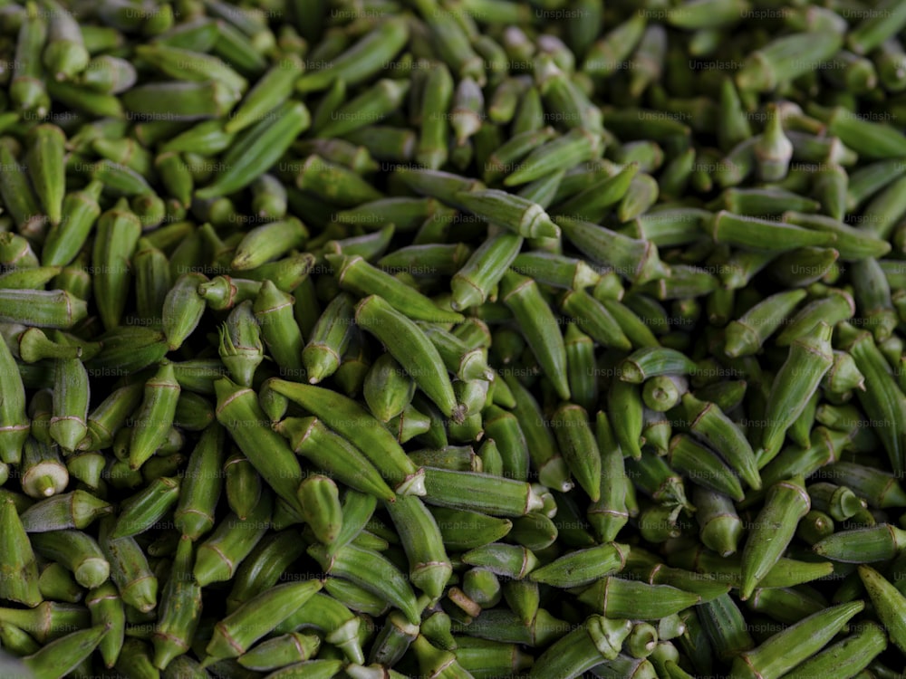 a large pile of green beans sitting on top of a table