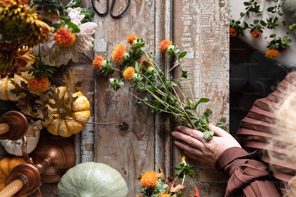 a woman is arranging flowers on a door