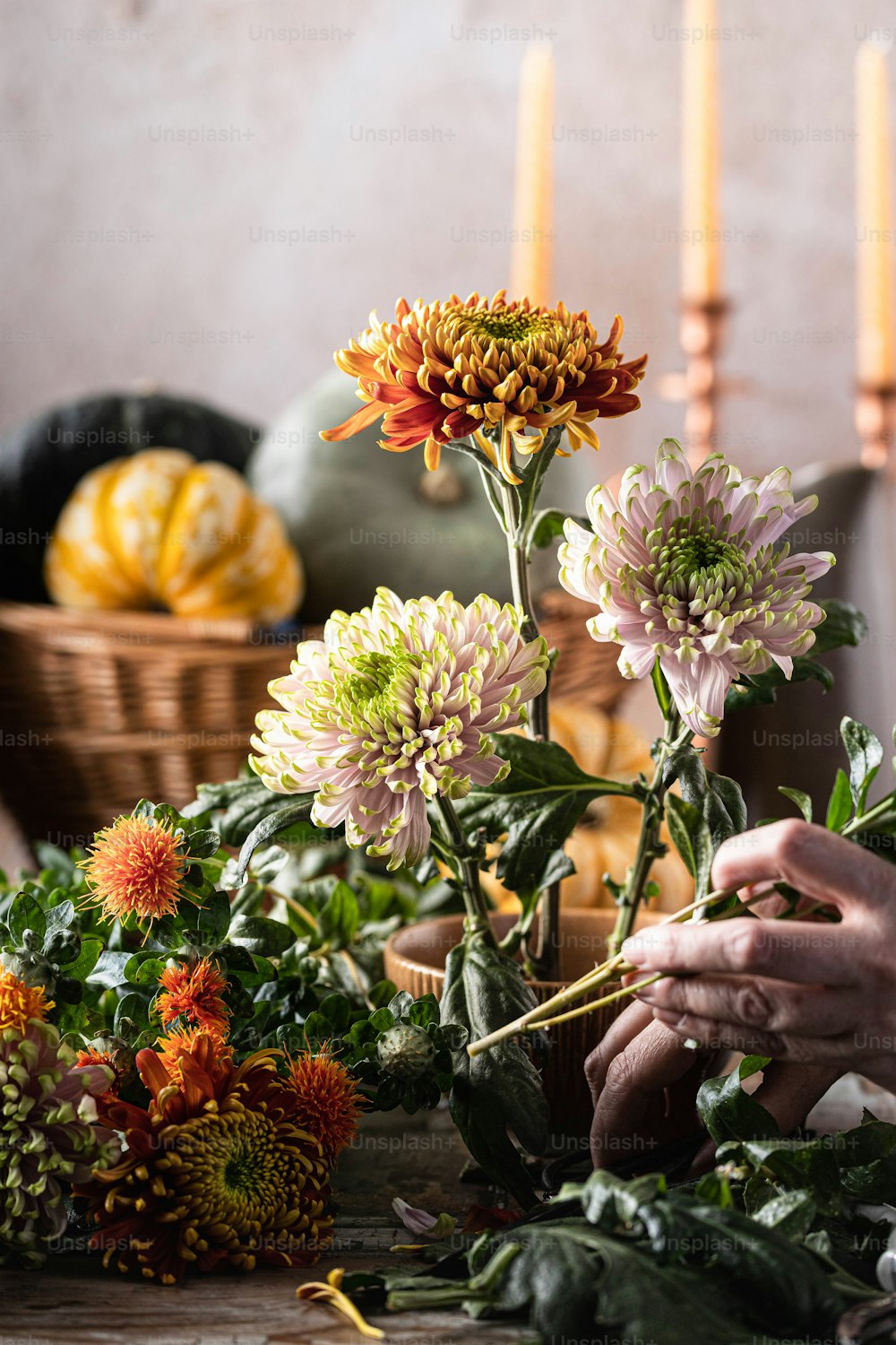 a person arranging flowers on a table