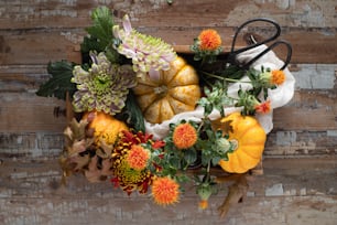 a bunch of flowers and pumpkins on a table
