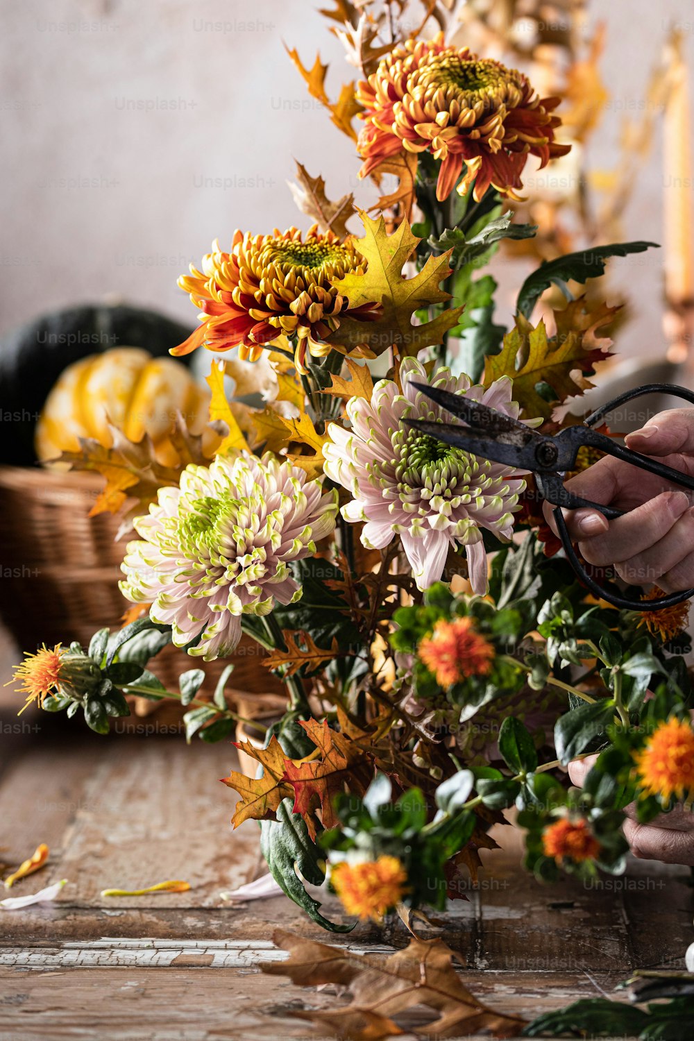 a person cutting flowers with a pair of scissors