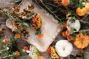 a bunch of flowers and pumpkins on a table