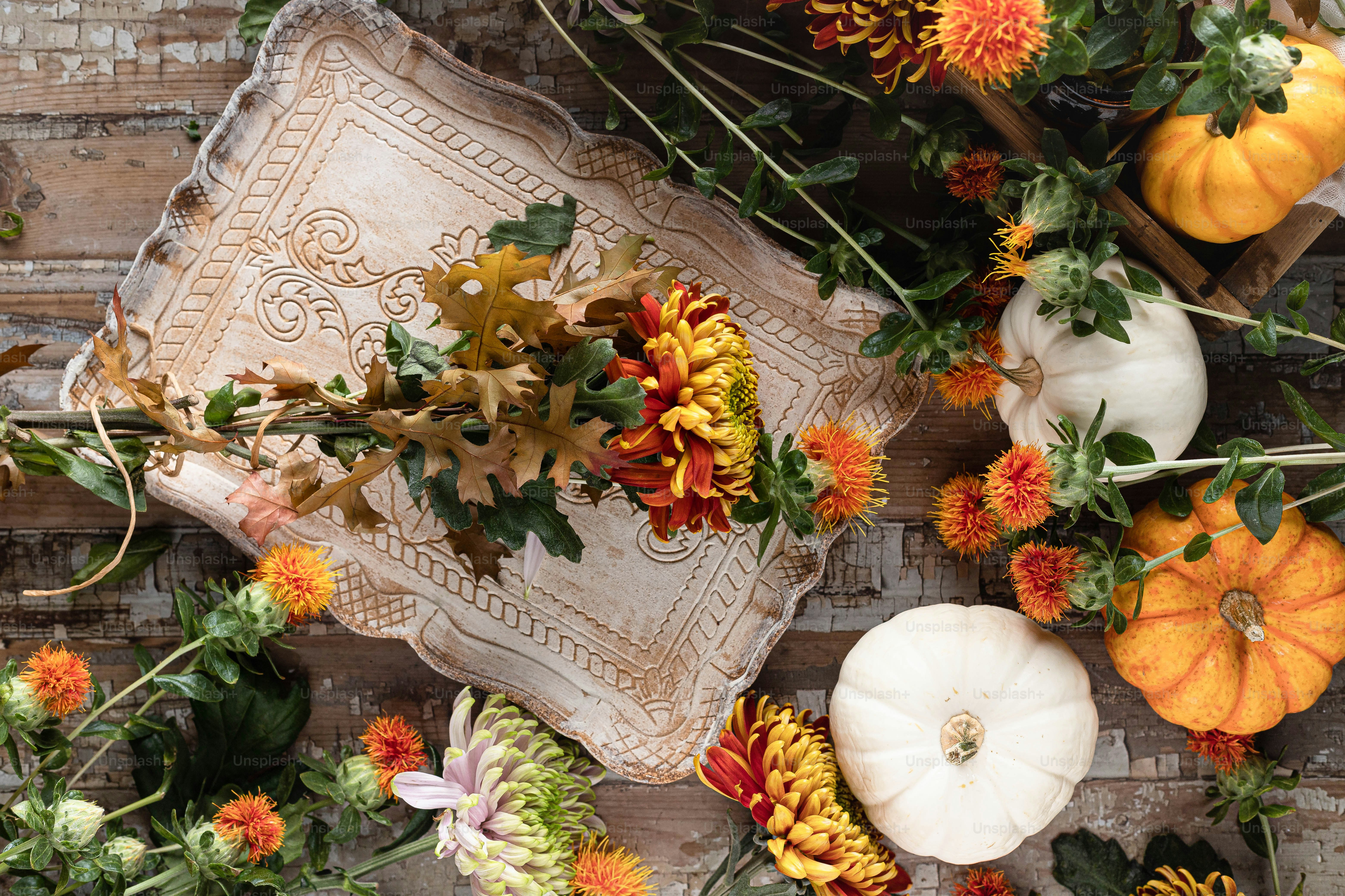 a bunch of flowers and pumpkins on a table