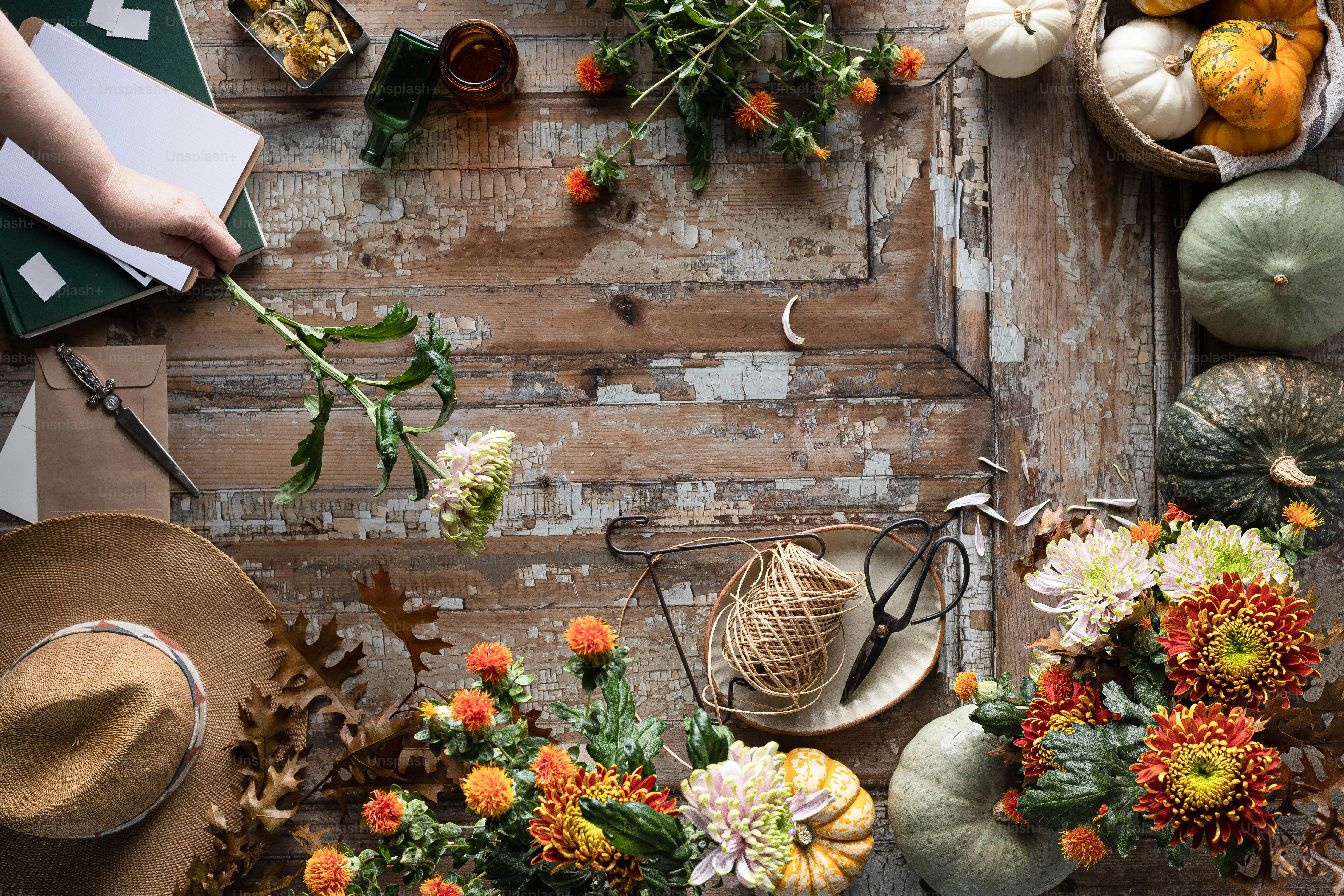 une table en bois surmontée de nombreux types de fleurs