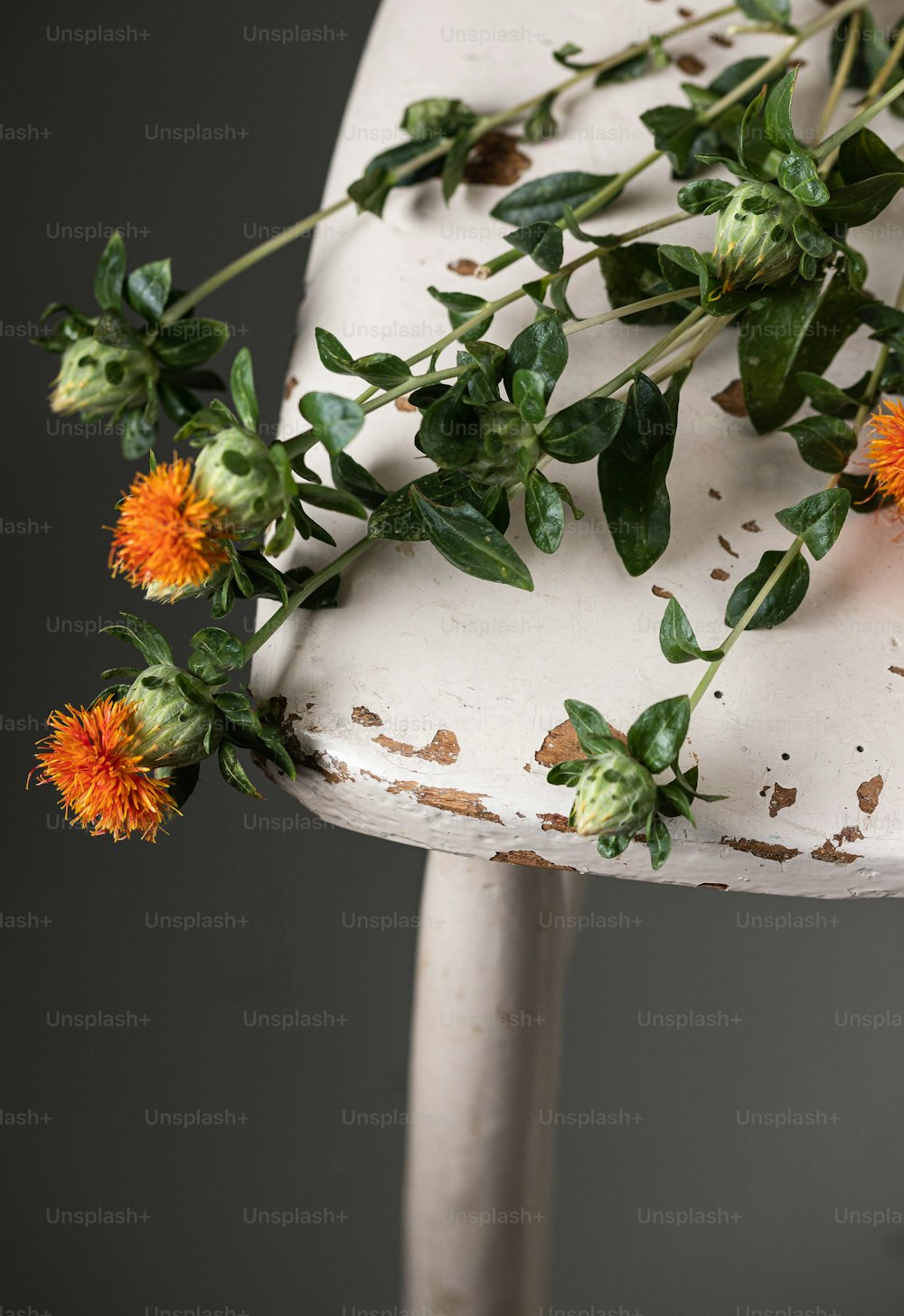 a white chair with a bunch of flowers on it